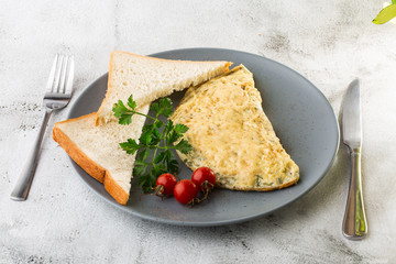 Omelet with cheese, cherry tomatoes and sourdough toast isolated on white marble background. Homemade food. Tasty breakfast. Selective focus. Hotizontal photo.
