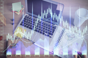 Double exposure of man's hands writing notes of stock market with forex chart.