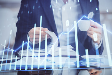 Double exposure of businessman with coffee with stock market forex chart.