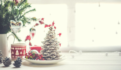 Christmas or new year still life with ornaments on rustic white table. Christmas cookies with festive decoration. Homemade gingerbread. Winter decoration background. Copy space for text.