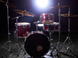 drum set isolated over dark background with lights