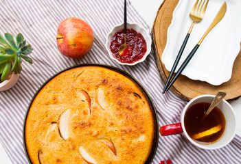 Christmas apple pie with jam and te with lemon. Food flat lay top view.