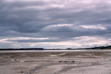 Clouds hanging above the beach in the evening.
