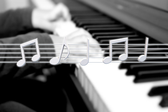 Hands of kid playing piano. Finger press on white key