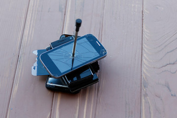Fototapeta na wymiar smartphone lies on a wooden background. it is broken. close-up.