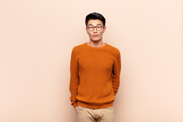 young chinese man looking goofy and funny with a silly cross-eyed expression, joking and fooling...
