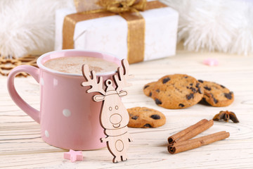 Cappuccino in a pink cup. Cookies with chocolate. The cozy home life. Wintertime.