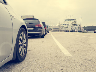 Angle view of cars parked in line waiting to board ferry.