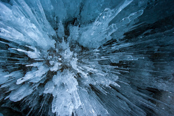 Natural textural background. Icy stalactites from transparent ice.