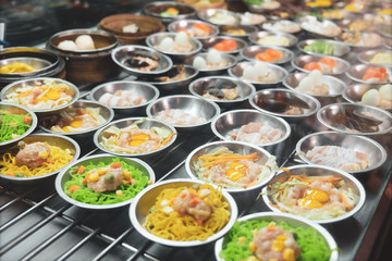 Many Dim Sum lined up in a restaurant.