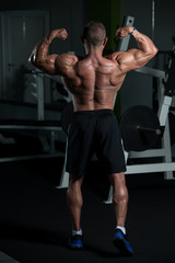 Fototapeta na wymiar Mature Bodybuilder Flexing Muscles