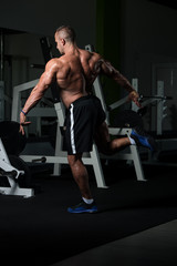 Obraz na płótnie Canvas Mature Bodybuilder Flexing Muscles