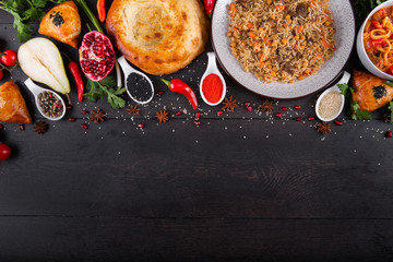 The concept of Eastern asian festive cuisine. Assorted Uzbek food set, pilaf, samsa, lagman, manti, shurpa restaurant concept Eastern arabic new year and Christmas dish from lamb served cookware.