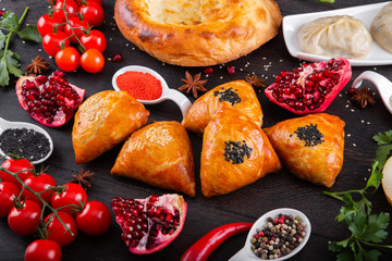 The concept of Eastern asian festive cuisine. Assorted Uzbek food set, pilaf, samsa, lagman, manti, shurpa restaurant concept Eastern arabic new year and Christmas dish from lamb served cookware.