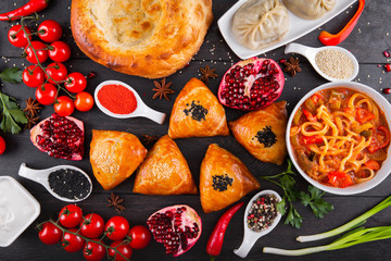 The concept of Eastern asian festive cuisine. Assorted Uzbek food set, pilaf, samsa, lagman, manti, shurpa restaurant concept Eastern arabic new year and Christmas dish from lamb served cookware.
