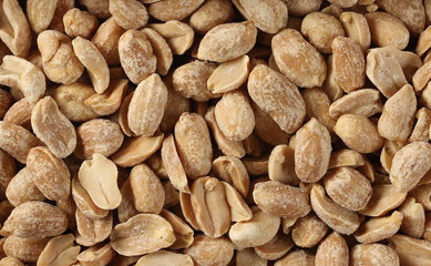 Salted and marinated peanuts background and texture