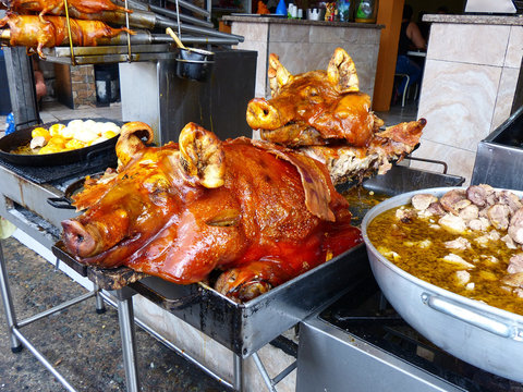 Ecuadorian typical food at local restaurant in Cuenca. Chancho Hornado (whole roasted pork), Fritada (fried pork meat) in big cooking bowl, Cuy (guinea pig), potato balls