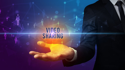 Elegant hand holding VIDEO SHARING inscription, social networking concept