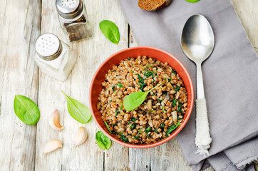 spinach, mushrooms buckwheat with spinach leaves