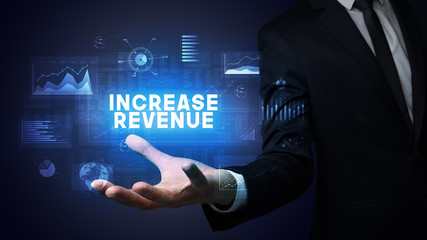 Hand of Businessman holding INCREASE REVENUE inscription, business success concept