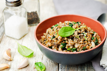 spinach, mushrooms buckwheat with spinach leaves