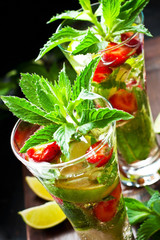 Summer  cold drink (juice, cocktail, fruit tea) with berries, selective focus