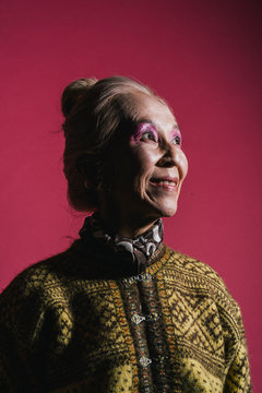 影になっている、柄模様のセーターを着たシニア女性のポートレート