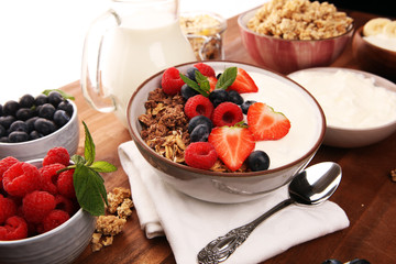 Tasty homemade granola served on table. Healthy breakfast with a bowl of oatmeal with banana, blueberries, strawberries and healthy food for Breakfast