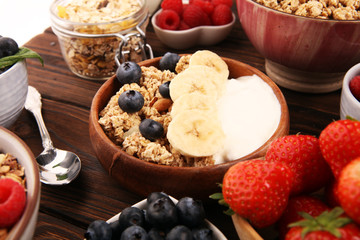 Tasty homemade granola served on table. Healthy breakfast with a bowl of oatmeal with banana, blueberries, strawberries and healthy food for Breakfast