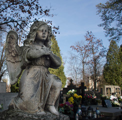 Monument and candles in the cemetery. All Saints Day in Poland.