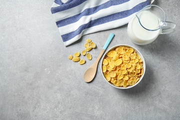 Tasty corn flakes on light grey table, flat lay. Space for text