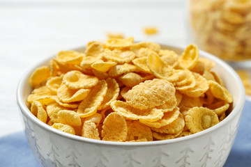 Tasty corn flakes on white table, closeup