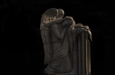 Monument and candles in the cemetery. All Saints Day in Poland.