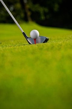 Golf club and ball on tee