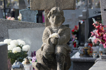 Naklejka premium Monument and candles in the cemetery. All Saints Day in Poland.