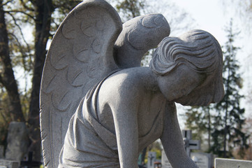 Monument and candles in the cemetery. All Saints Day in Poland.