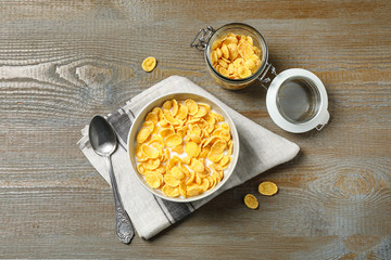Flat lay composition with tasty corn flakes on wooden table