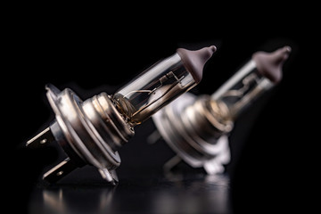 Blown car bulbs on a dark table. Spare parts for passenger cars.
