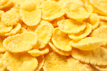 Tasty crispy corn flakes as background, closeup