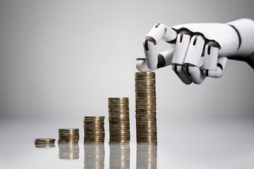 Robotic Hand Placing Coin Over The Increasing Coins Stack