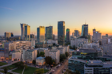 Drone shot at skyscrapers and buildings at dusk at sunset in Warsaw. Poland. 19. October.  2019. Aerial view of the city of Warsaw, skyscrapers and buildings, evening autumn evening sunset.