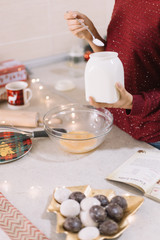 Female hands holding white jar with flour