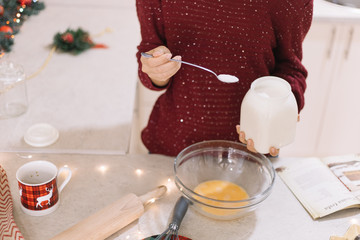 Woman holding jar and spoon with flour