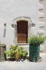 Fototapeta na wymiar Brown door with flowers, Greece, Crete