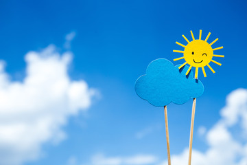 paper cut winking sun and blue cloud on sticks