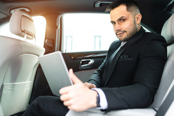 Young caucasian man with beard and dressed in formal wear sit with laptop and work, business people concept