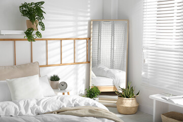 Modern bedroom interior with stylish large mirror
