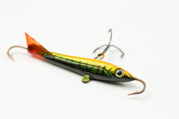 Fishing spinners and wobblers multi-colored on a background of artificial green grass. 
