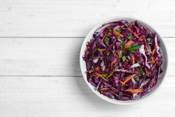 Fresh red cabbage salad on white wooden table, top view. Space for text