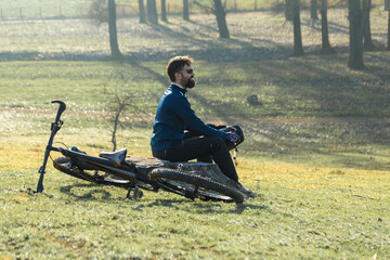 Cyclist in pants and fleece jacket on a modern carbon hardtail bike with an air suspension fork rides off-road.	